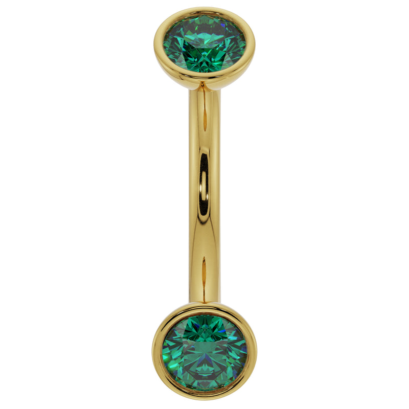 14k yellow gold 14G curved barbell with larger bezel-set emeralds, showing fuller stone size