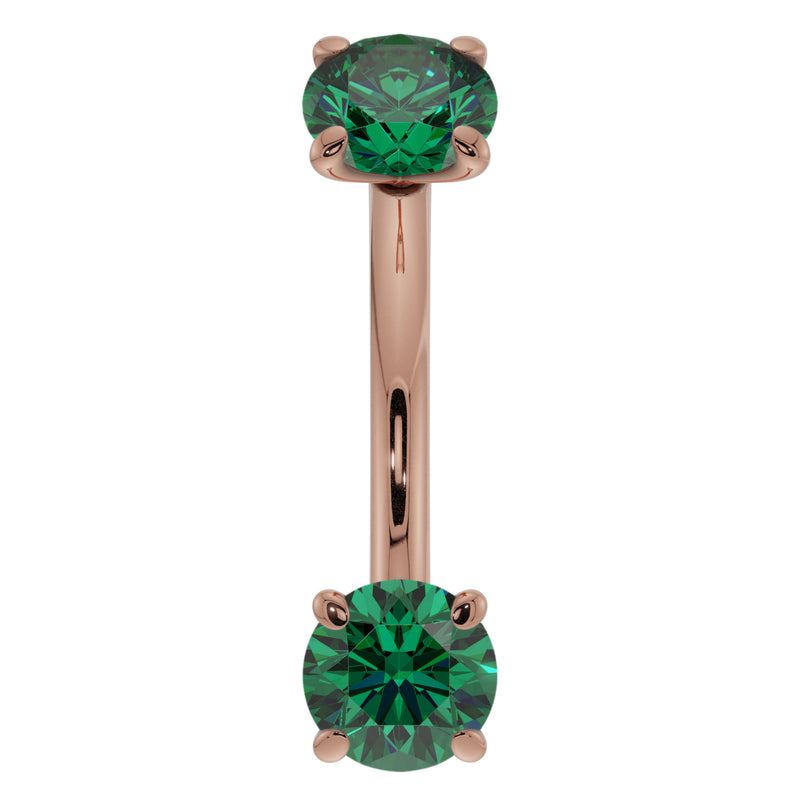 Close-up front view of 14K rose gold emerald curved barbell highlighting larger 14G stone size