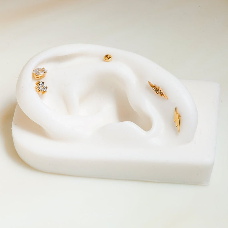 14k gold diamond pavé lightning bolt helix stud styled with plain bolt and other cartilage pieces
