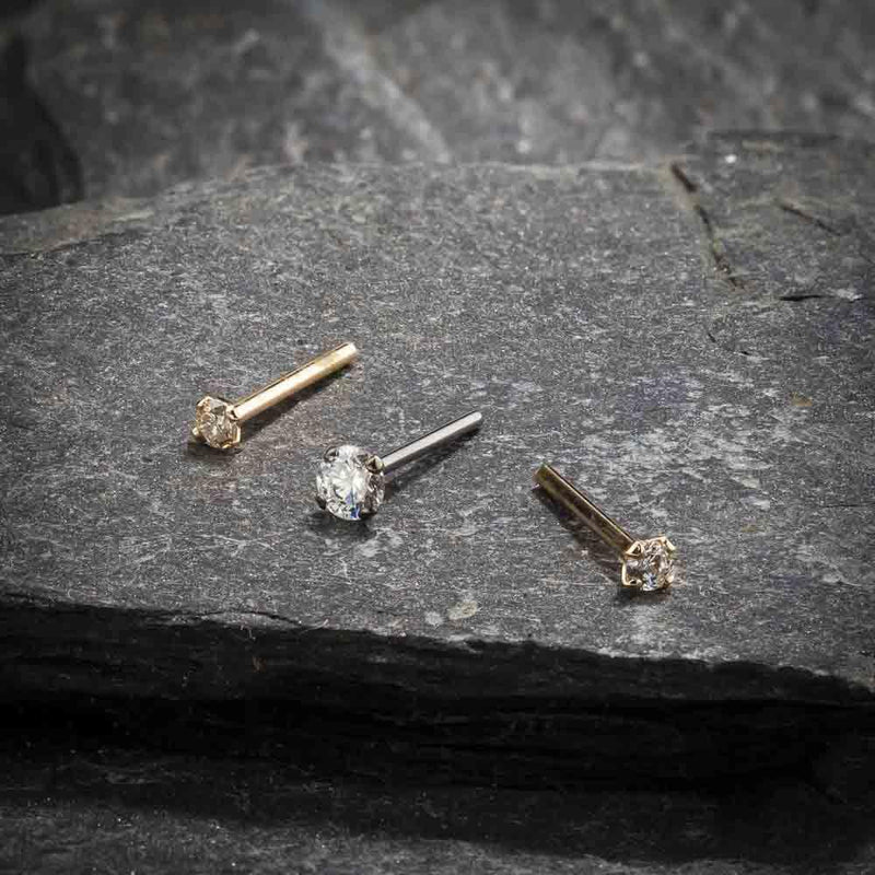 14k gold CZ straight post nose studs in yellow and white gold on slate, showing pin post style variety
