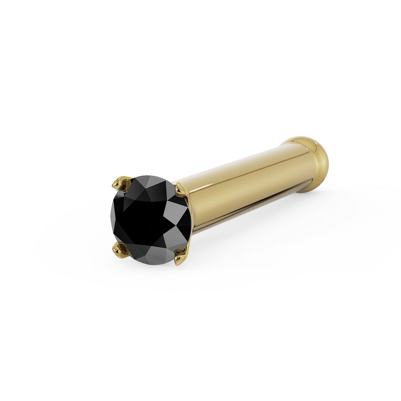 14k yellow gold black diamond nose bone stud showing rounded end and prong-set gem, angled view