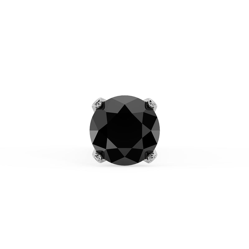 Close-up top-down view of 1.5mm black diamond in four-prong white gold setting, facets visible