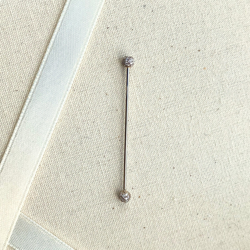 Diamond pavé straight barbell shown on linen fabric for size reference, full length visible