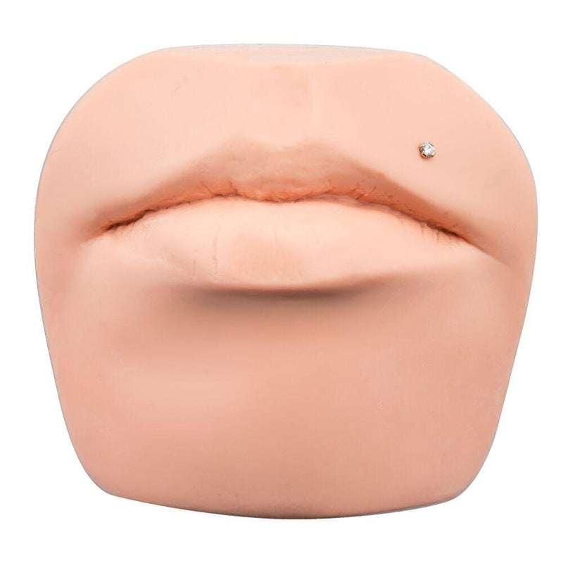 3mm CZ prong flat back stud shown in monroe lip piercing on a silicone face display model