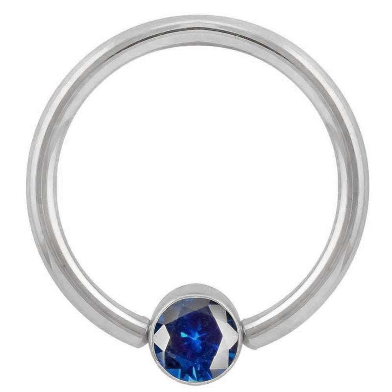 14k white gold blue CZ bezel fixed bead ring, angled front view highlighting cool-toned setting
