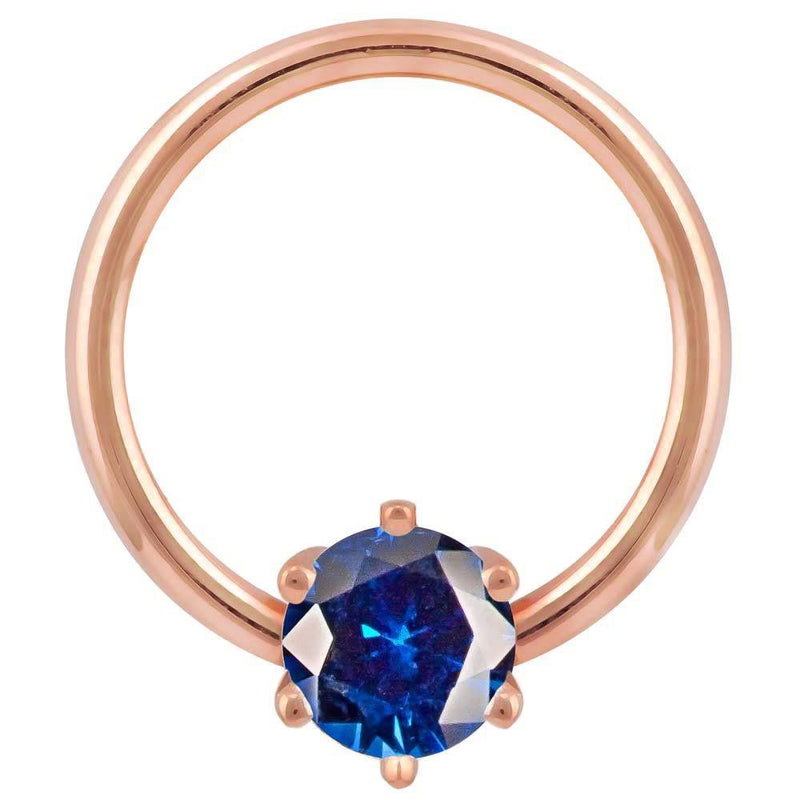 14k rose gold fixed bead ring with deep blue round CZ in six-prong setting, front view