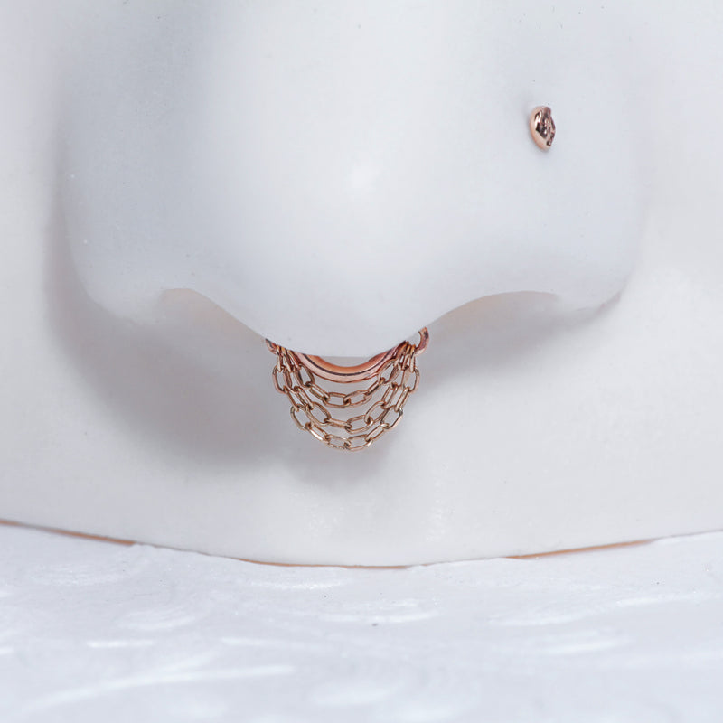 14k rose gold chain clicker hoop shown as septum ring on nose model, close-up