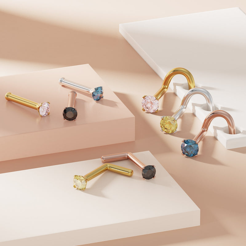 Assortment of colored diamond prong nose studs in yellow gold, rose gold, and white gold styles