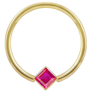14k yellow gold fixed bead ring with red princess-cut CZ in corner-mount bezel, front view