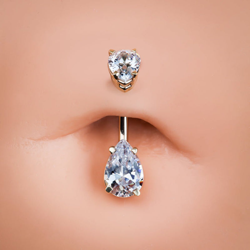 Double pear CZ 14k gold belly ring shown in a navel piercing for fit and scale reference