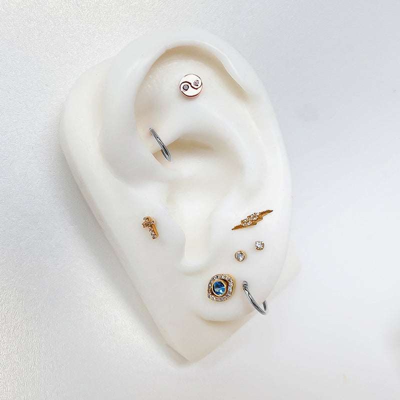 Platinum plain clicker hoop on ear display model styled with mixed metal cartilage jewelry
