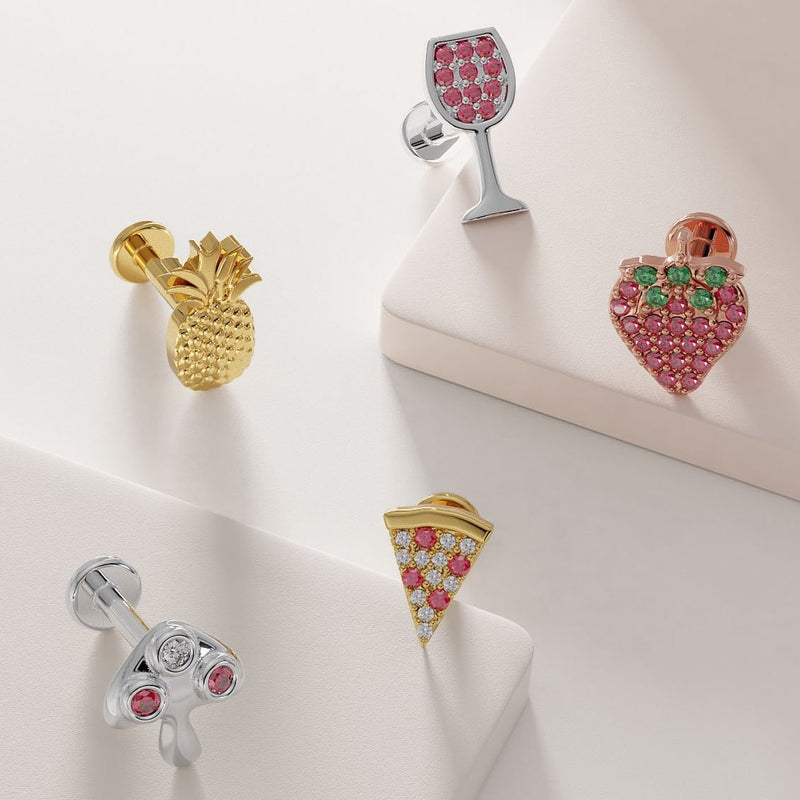 Diamond ruby mushroom labret shown alongside other fun gold flat back earring styles for scale