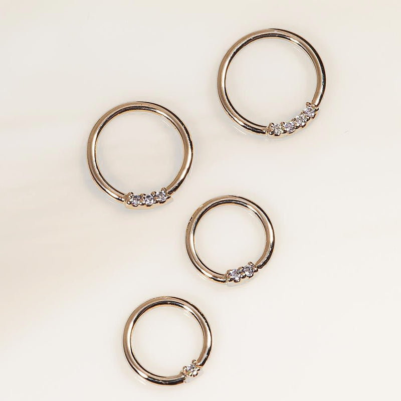 14K yellow gold two-diamond seam rings in four sizes shown flat on cream background