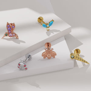 14K gold firefly flat back earring shown among nature-themed piercing jewelry collection on white surface