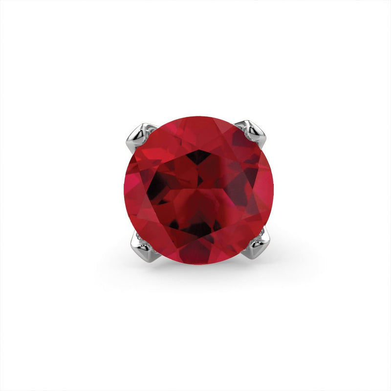 Close-up of genuine ruby gemstone in four-prong white gold setting, vivid red color detail view
