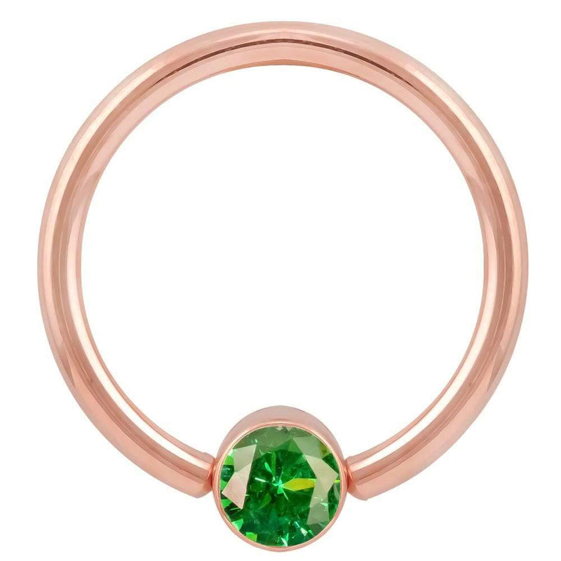 14k rose gold fixed bead ring with emerald green CZ bezel, larger gauge front view