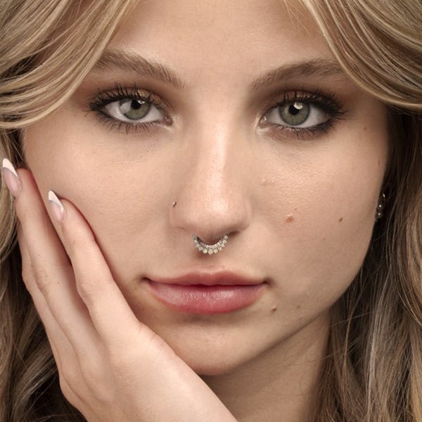 Opal and diamond 14k gold clicker ring hoop worn as a septum piercing on a female model