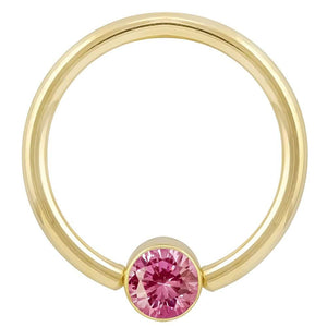 14k yellow gold fixed bead ring with bright pink round-cut CZ in bezel setting, front view