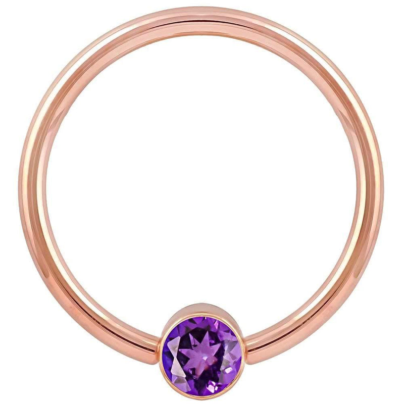 14k rose gold fixed bead ring with purple CZ round bezel setting, smaller gauge front view