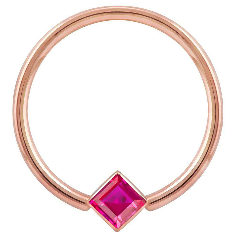 14k rose gold fixed bead ring with red princess-cut CZ in corner-mount bezel, front view
