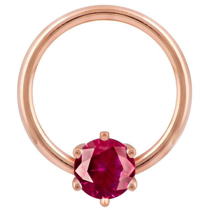 14k rose gold fixed bead ring with deep red round CZ in prong setting, front view