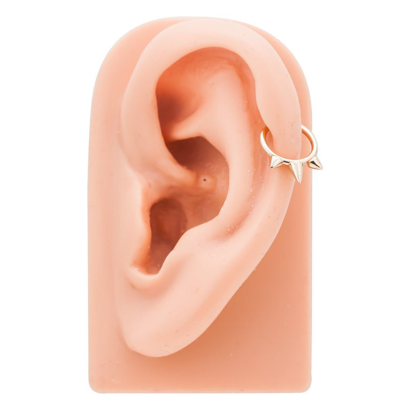 14K gold triple spike seam ring worn in cartilage piercing on ear model for fit reference