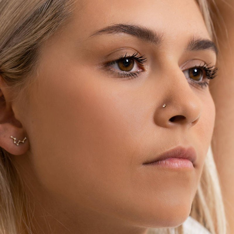 2.5mm diamond prong nose stud shown on model from front-facing three-quarter angle