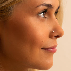 2.5mm diamond perlage nose ring shown in pierced nostril, side profile on model