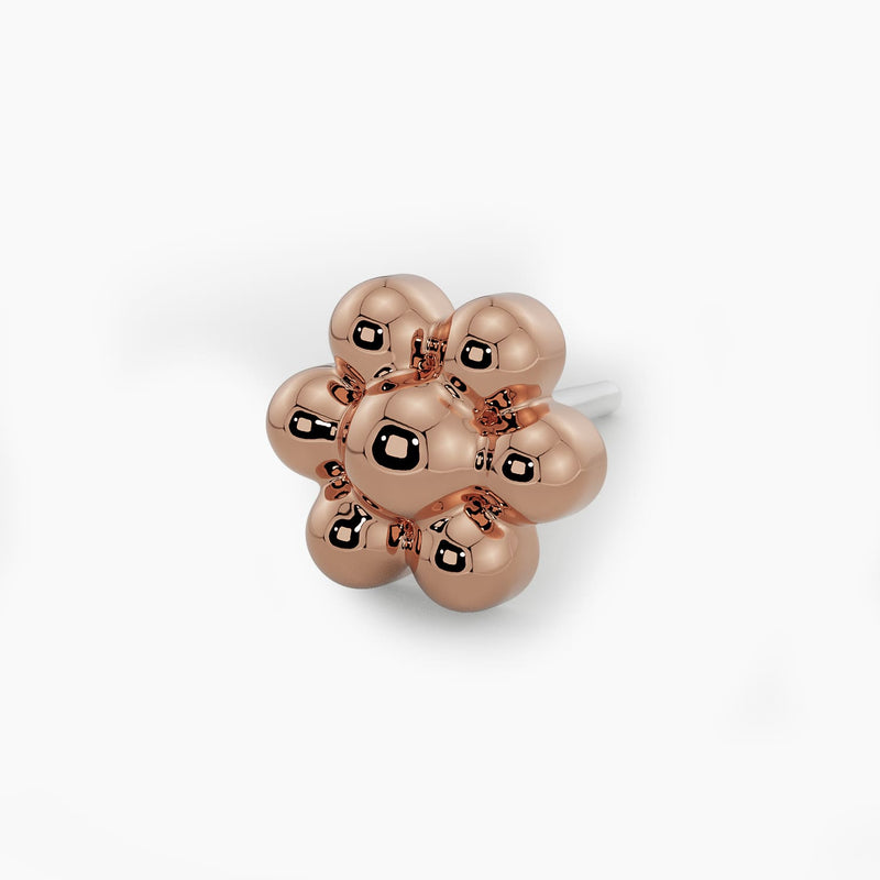 Macro close-up of 14k rose gold beaded flower end on threadless pushpin post