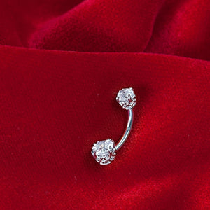 14k white gold diamond navel ring with filigree settings resting on red velvet, showing full curved barbell
