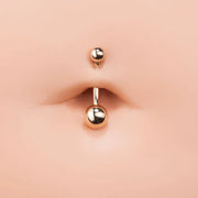 14k yellow gold double ball belly ring shown in navel piercing for fit and size reference