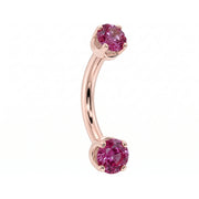 Dainty 2mm pink sapphire prong-set curved barbell in 14k rose gold, 18 gauge, angled view