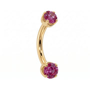 Dainty 2mm pink sapphire prong-set curved barbell in 14k yellow gold, 18 gauge, angled view