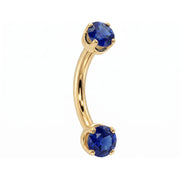 14k yellow gold dainty 18G curved barbell with two 2mm round blue sapphires, angled view