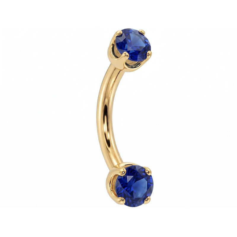 14k yellow gold dainty 18G curved barbell with two 2mm round blue sapphires, angled view