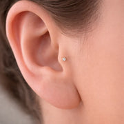 2mm diamond bezel flat back stud shown in model's earlobe piercing, minimal dainty fit