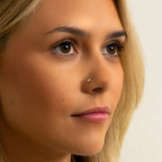 3mm diamond milgrain nose ring worn in nostril piercing, front-facing model view