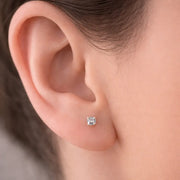 3.5mm diamond prong-set flat back labret stud worn in earlobe piercing for fit reference