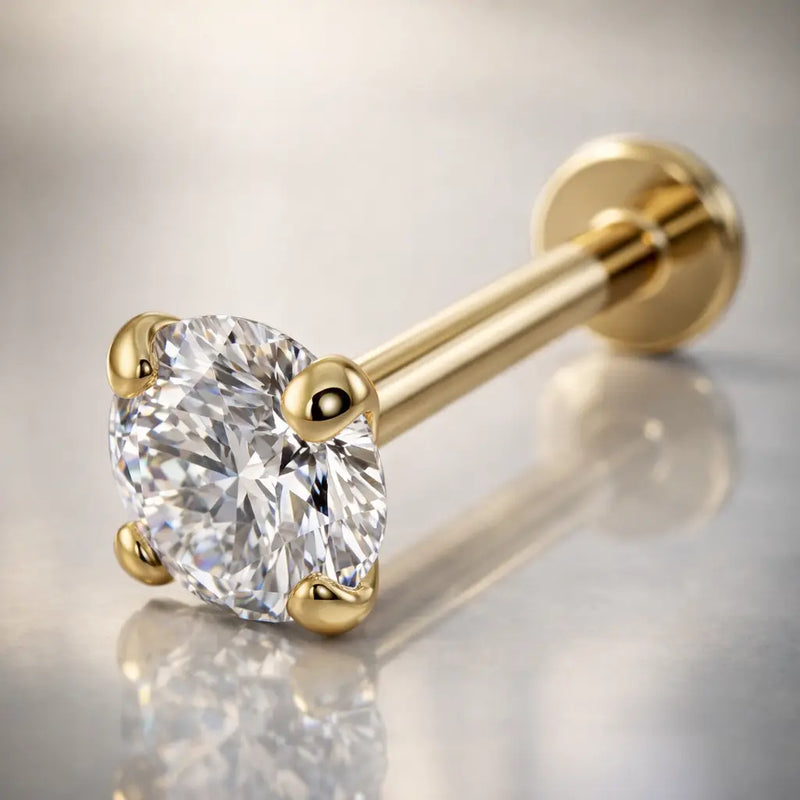 14k yellow gold 3.5mm diamond flat back labret on reflective surface, angled lifestyle shot