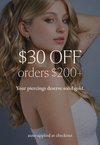 Promotional advertisement for a jewelry brand with a woman wearing gold earrings and text overlay.