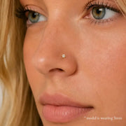Close-up of an woman's nose wearing Astra 6-prong 3mm diamond nose stud earring.