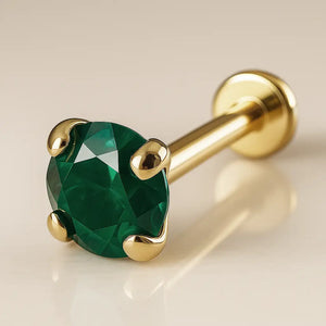 14K yellow gold flat back labret with 3mm emerald prong setting, angled product shot