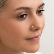 3mm diamond prong nose stud shown in pierced nose on fair-skinned model, front-facing portrait