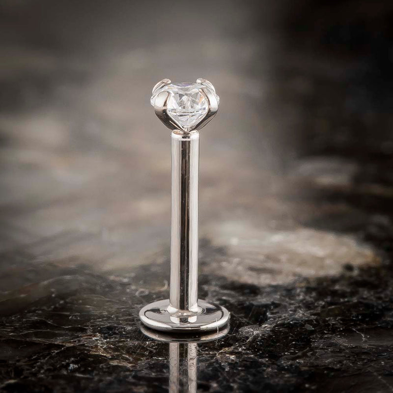 14k white gold 3mm diamond flat back labret stud standing upright on dark marble, front view