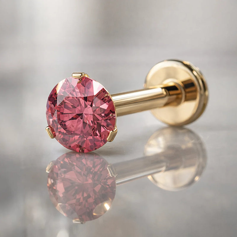 3mm pink diamond flat back labret in 14k yellow gold, angled studio shot showing prong setting and flat disc