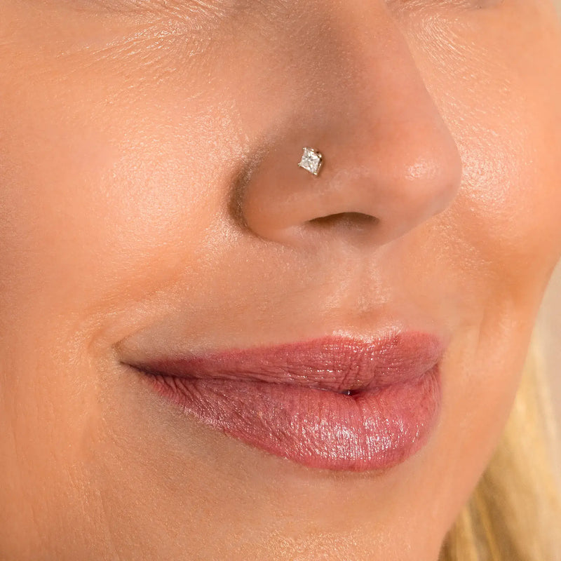 3mm princess-cut diamond nose stud shown in pierced nostril on model for fit and size reference