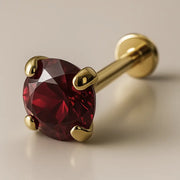 3mm ruby flat back labret in 14K yellow gold with four-prong setting, angled studio view