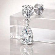 14k white gold diamond pear drop flat back stud on acrylic surface, angled view showing classic size sparkle
