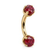 14k yellow gold curved barbell with two 4mm round rubies, angled view