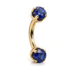 14k yellow gold curved barbell with two 4mm round blue sapphires, angled view